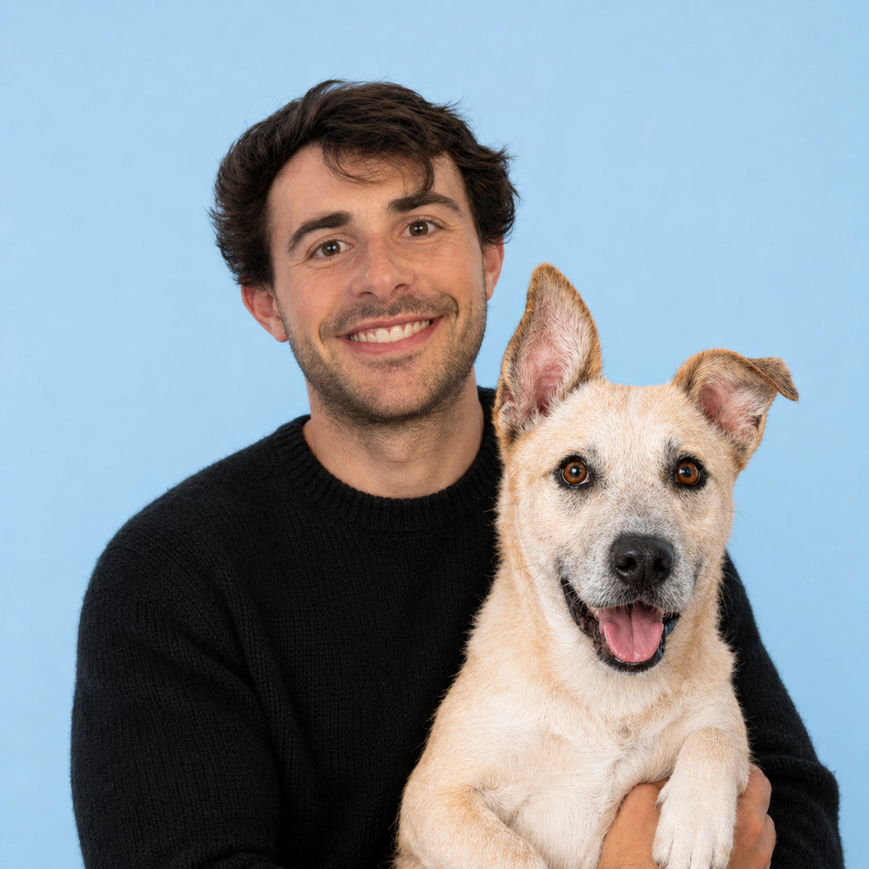 The founder of Pawfolio holding Lassie, his adopted dog